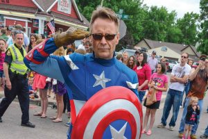 Steve Jorgenson, aka Captain America, salutes people lining Mountain Avenue during the Berthoud Day parade on Saturday, June 7 in Berthoud. Jorgenson participated in the parade as part of Calvary Berthoud's float and was popular at Town Park, taking pictures and handing out balloons for kids and others.  John Gardner/ the Surveyor 