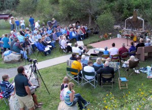 A crowd gathered early in the evening at the Drake fire station to remember both floods in the canyon.