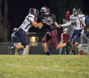 Berthoud wide receiver Jackson Hall, 83, breaks a tackle against a Northridge defender on Oct. 24 at Max Marr Field in Berthoud. This was Hall’s second touchdown in the game, and two-TD game for the second week in a row, but that wasn’t enough to overcome Northridge.  John Gardner / The Surveyor