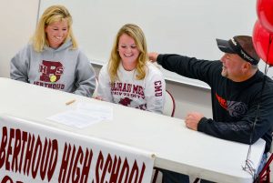 Berthoud's Jessi Boruff and her parents, Sandi and Doug Boruff, react after Jessi signed her letter of intent to play softball at Colorado Mesa University in Grand Junction, on Nov. 12 at BHS. John Gardner / The Surveyor