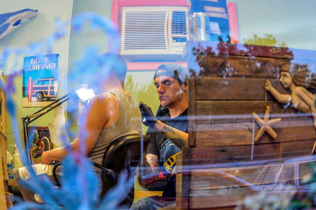 Surfbilly Tattoo owner and tattoo artist, J.D. Markwardt, tattoos Berthoud resident Jeff Wicks on an October evening, just a few weeks after opening the tattoo parlor located at 435 Third St. in Berthoud.  John Gardner / The Surveyor