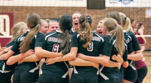 The Berthoud High School volleyball team celebrates its victory at regionals on Nov. 1 at Berthoud High School. The team is on its way to the state championships, Nov. 7-8 at the Denver Coliseum, for the first time since 2008.  Paula Megenhardt / The Surveyor