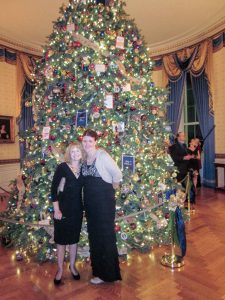 Carin Barrett, right, poses in front of the White House’s offi cal Christmas tree, along with fellow Berthoud High School teacher Ann Gonzales, who accompanied Barrett to the volunteer reception for those who decorated the house for the holidays. Barrett was one of 76 volunteers selected to help decorate the White House for the Christmas holiday this year. Photo courtesy of Carin Barrett / The Surveyor