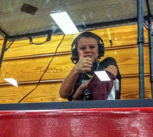 Berthoud’s Kolten Strait gives a thumbs-up while broadcasting a wrestling match at Berthoud High School for Overtime Sports Net. Photo courtesy of Jill Strait / The Surveyor