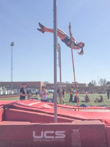 Berthoud’s Kelly Chamberlain soars almost a foot above her personal best in teh pole vault, clearing 10 feet at the Runner’s Roost Invitational in Fort Collins on March 21. Photo courtesy of Lisa Spitz / The Surveyor