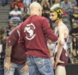 Colin Leypoldt speaks with his coaches during a match at the state wrestling tournament in Denver on Feb. 20. 