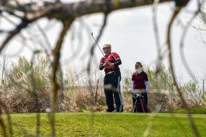 Berthoud's Molli Boruff watches her tee shot on the par-3 10th hole at The Mad Russian Golf Course in Milliken on April 20. Boruff won the contest with a low round, 85.  John Gardner / The Surveyor