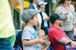 Bennet Soricelli enjoys a piece of candy as he watches last year’s Berthoud Day Parade floats go by on Mountain Avenue. This year marks the 61st annual event that kicks off the summer season. Surveyor file photo