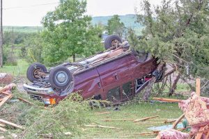 The storm's 140 mile per hour winds flipped vehicles like toy cars, like this one pictured in the Eyl's driveway on Blue Mountain Avenue.  Becky Justice-Hemmann / The Surveyor
