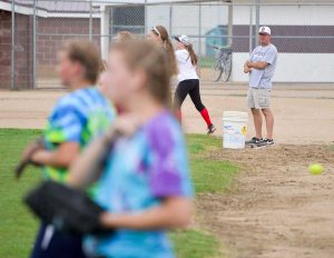 First year softball head coach Buddy Kouns watches as more than 30 girls practice at Bein Field at Berthoud High School on Aug. 18. Kouns may be new to the top spot in Spartans softball but he’s been, and remains, Berthoud’s baseball coach. Kouns said that this year there is a lot of interest for the team and the amount of girls who’ve come out for a spot on the team is higher than it’s been in years. John Gardner / The Surveyor