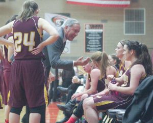 Berthoud girls basketball head coach Randy Earl speaks to his team during a break in the game against Erie last season. The Spartans return a core group of experienced players that will benefit the team this season. Surveyor file photo