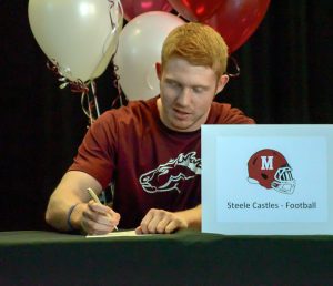 Steele Castles signs his letter of intent to play football during a signing ceremony at Berthoud High School on Feb. 3.