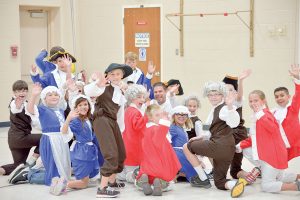 Ivy Stockwell fi fth grade teacher Jason Hooker, center, is surrounded by his class during a reenactment of the writing of the Constitution on Constitution Day in 2015. Surveyor file photo