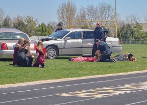 Berthoud students and fi rst responders act out a crash scene at Max Marr Field at Berthoud High School on Friday, April 22 in a mock drinking and driving event aimed at teaching students the perils of drinking and driving. May Soricelli / The Surveyor 