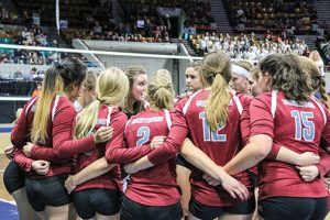 The Berthoud Spartans volleyball team gets a pep-talk from head coach Daisha Agho during the contest with Lewis-Palmer in the first round of the 4A state volleyball tournament on Nov. 11 at the Denver Coliseum. Paula Megenhardt / The Surveyor
