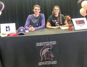 Berthoud High School students Liam Gately, left, and Hannah Langer, right, signed their letters of intent at BHS on Tuesday. Gately committed to Northwestern University for swimming while Langer committed Hastings College in Nebraska for softball. Dan Karpiel / the Surveyor