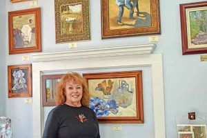 Homestead Fine Art Gallery’s Peggy Keagle stands by some of her art in the gallery she shares with nine other artists. Bob McDonnell / The Surveyor