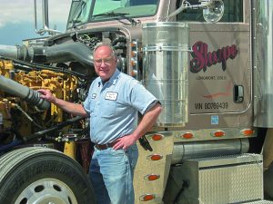 George Wood pictured near one of the trucks he spent his career working on. Courtesy Heavy Duty Truck Repair