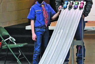 Cub Scouts raced cars in the annual Pinewood Derby competition – coming up the Rain Gutter Regatta